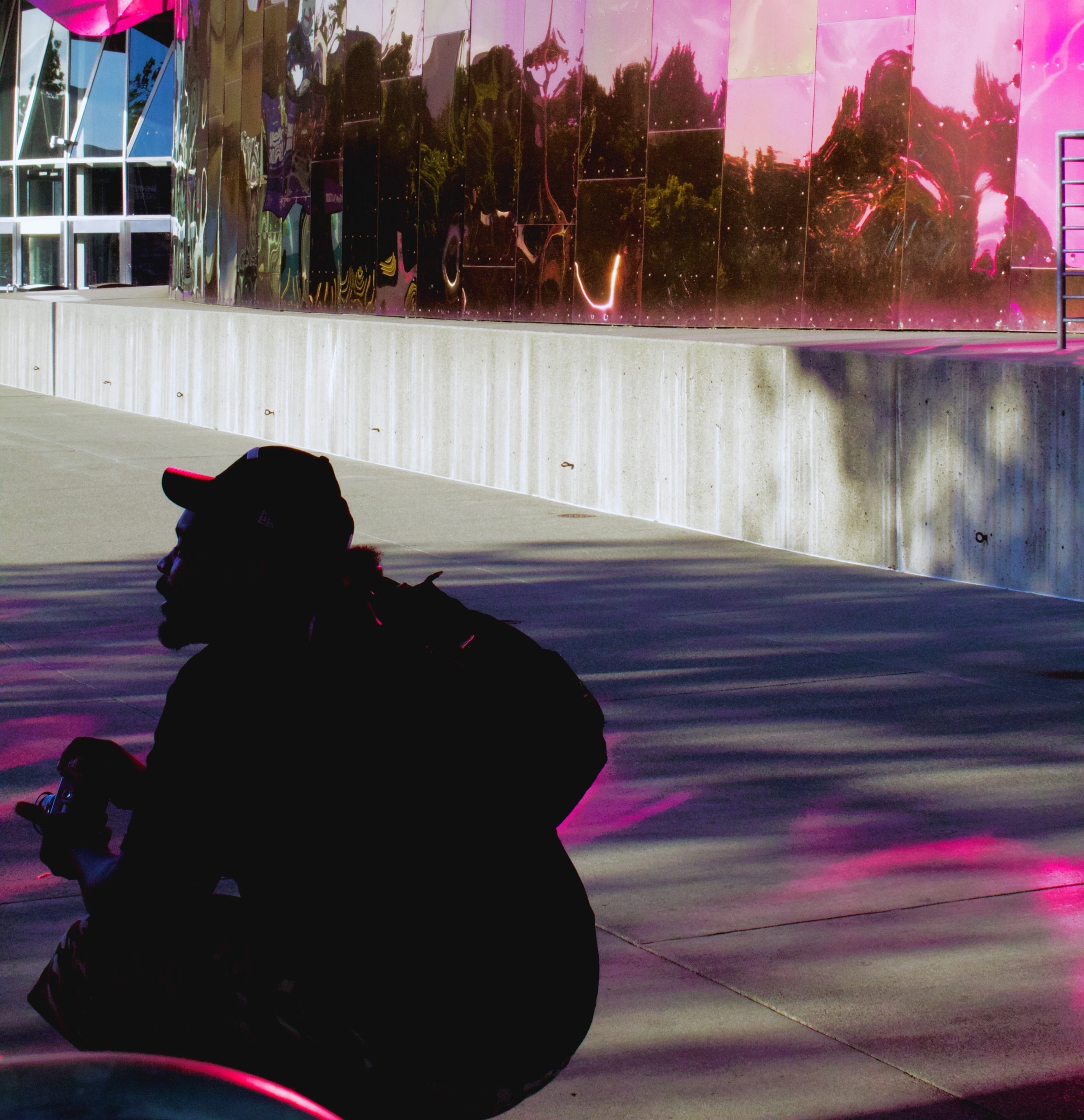 site owner crouched while holding a camera.